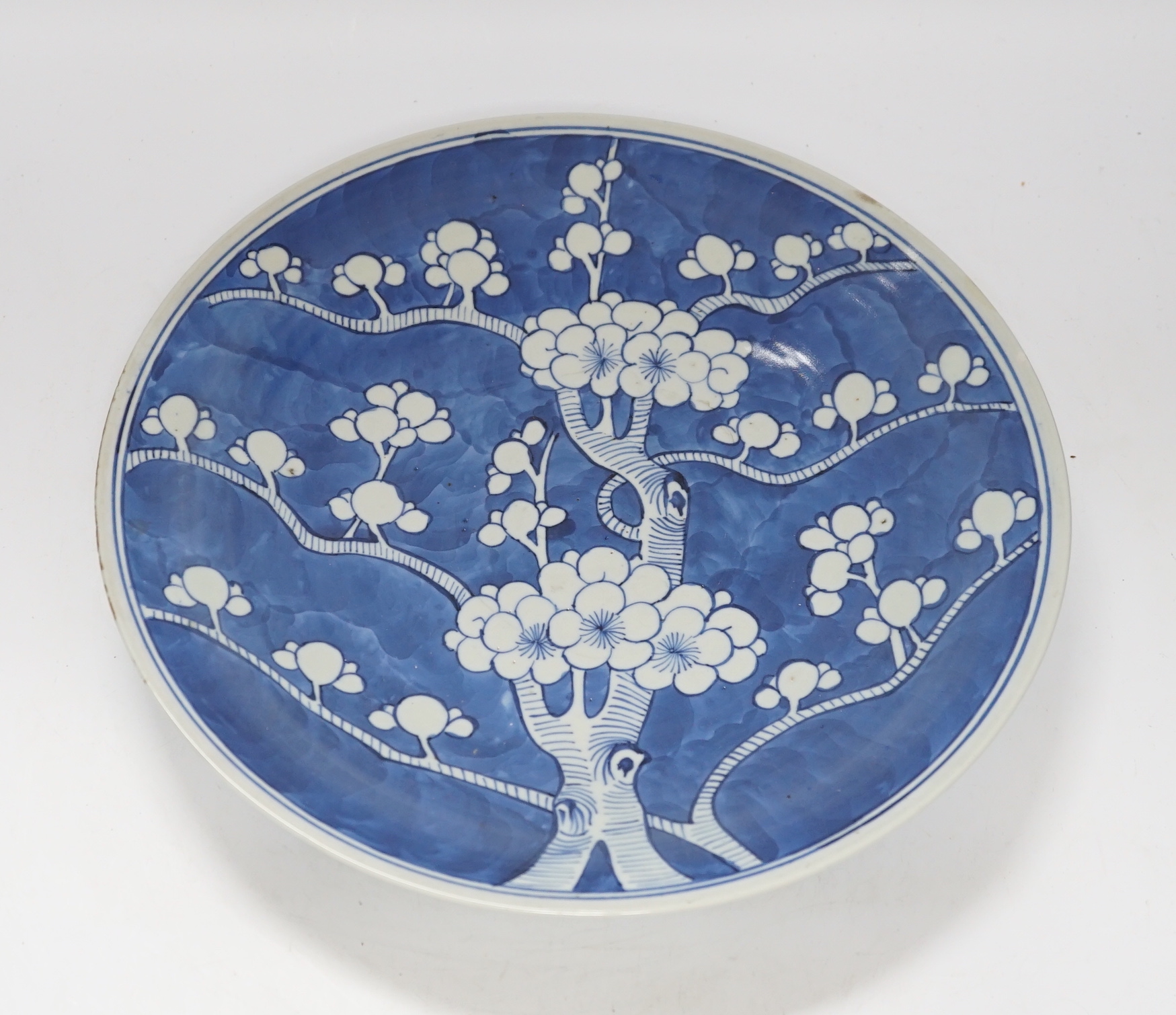 A 19th century Chinese blue and white Prunus dish, 33cm diameter
